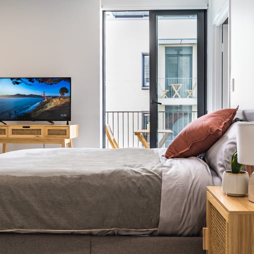 a bedroom with a bed and a flatscreen tv