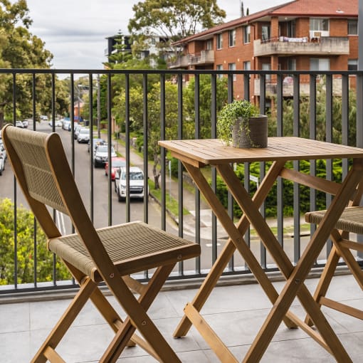 a patio with a table and chairs on a balcony