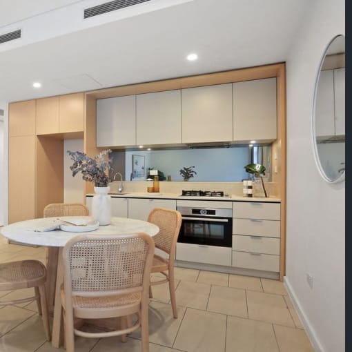 a kitchen and dining area with a table and chairs