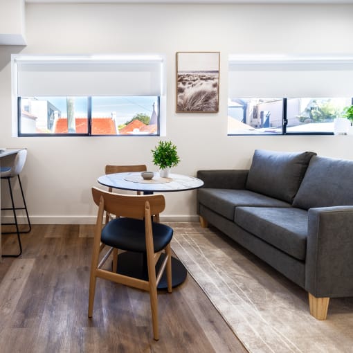 a living room with a kitchen and a couch and a table