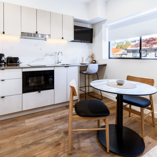 a kitchen and dining area with a small table and chairs