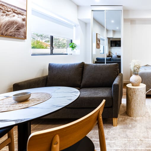 a living room with a couch and a table and a bed