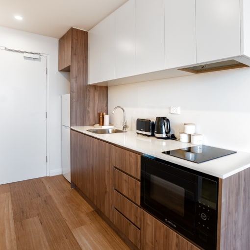 a kitchen with wooden cabinets and a counter top and a sink