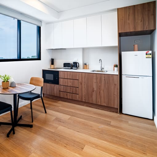 a kitchen and dining area with a table and chairs