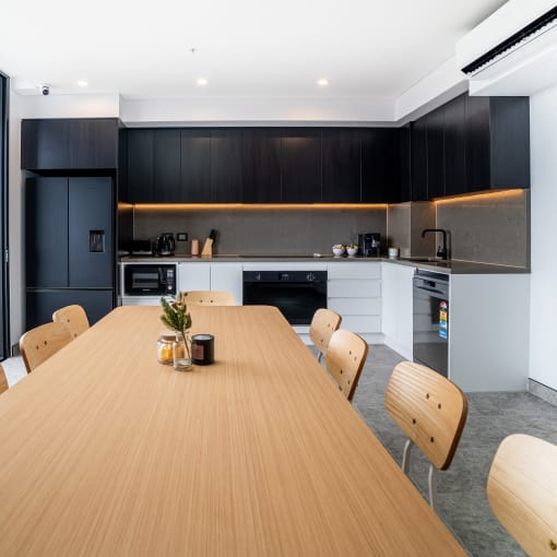 a kitchen and dining area with a wooden table and chairs