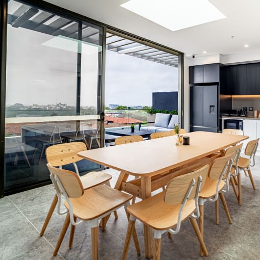 a kitchen and dining area with a wooden table and chairs