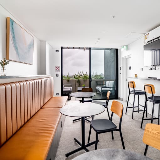 a dining room with tables and chairs and a bar