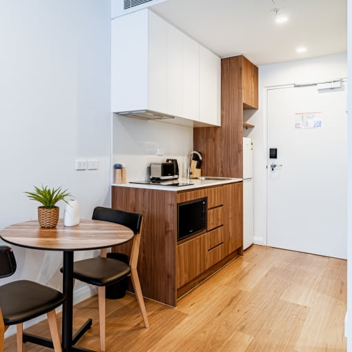 a kitchen and dining area with a table and chairs