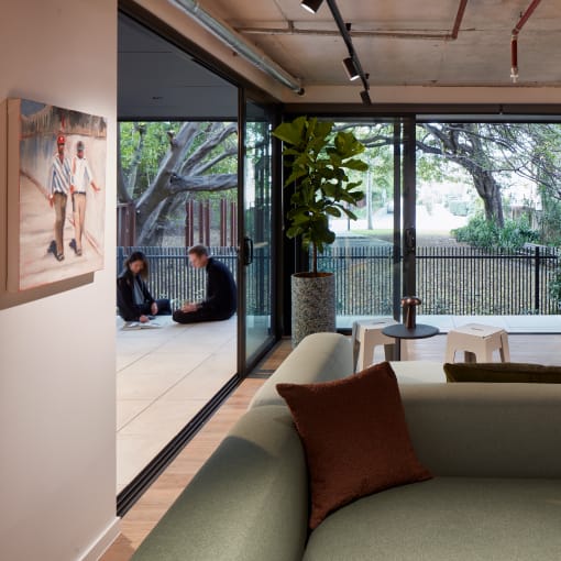 a living room with couches and a table and some windows