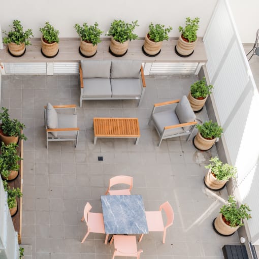 arial view of a patio with tables and chairs and potted plants