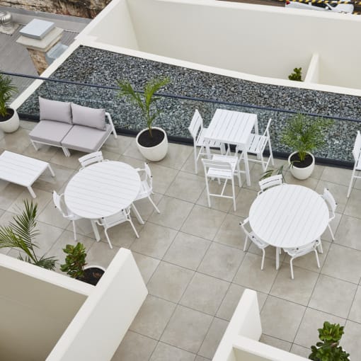 an aerial view of a patio with chairs and tables