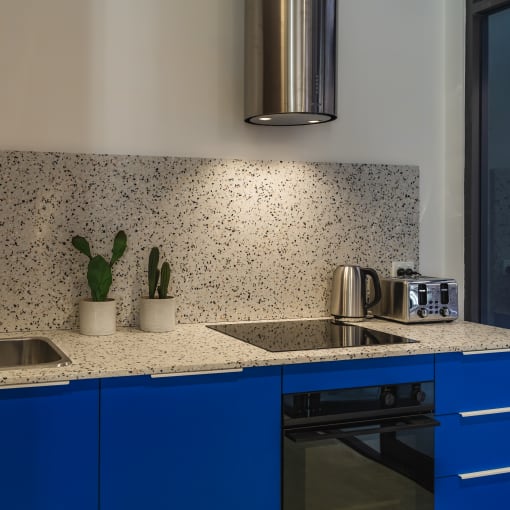 a kitchen with blue cabinets and a counter top and a sink