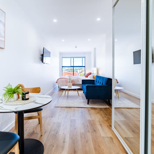 a living room with a blue couch and a table