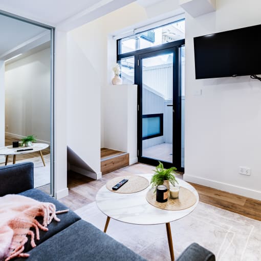 a living room with a couch and a table and a television