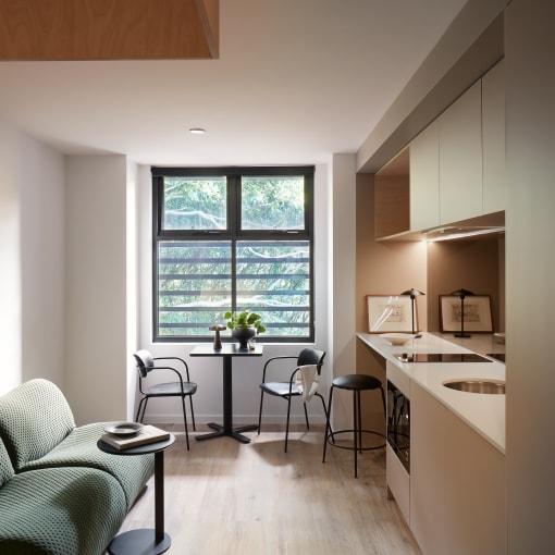 a living room with a couch and a table and a window