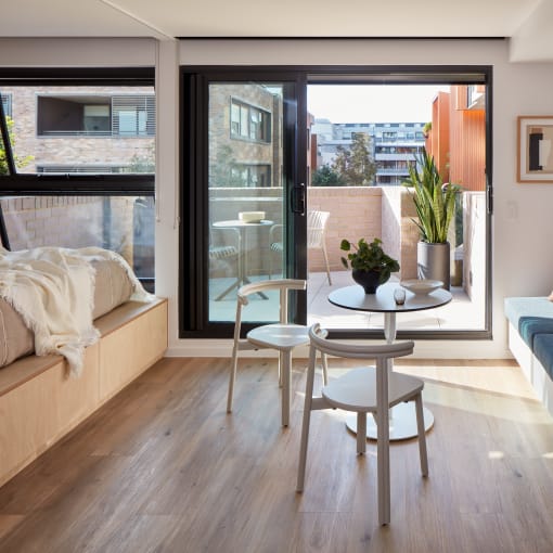 a living room with a couch and a table and a balcony