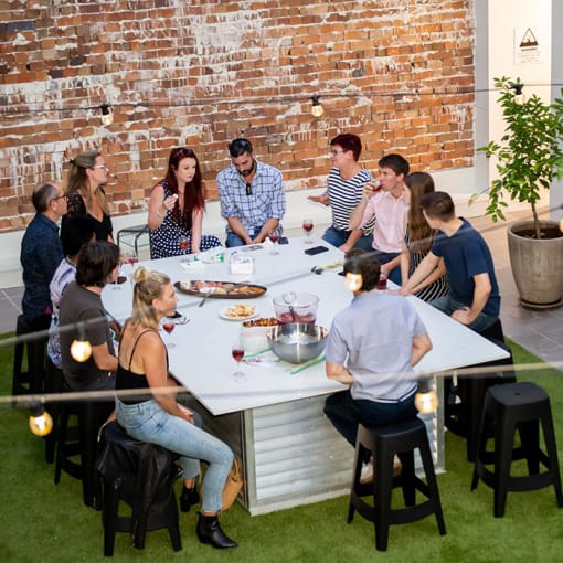 a group of people sitting around a table in a restaurant