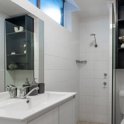 a bathroom with a toilet and a sink and a shower