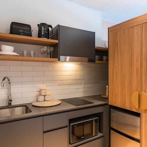 a kitchen with a sink and a wooden cabinet