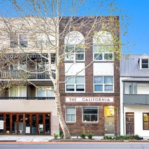 a brick building with a sign that reads the