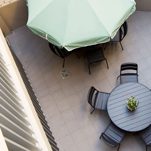 an aerial view of a patio with a table and chairs