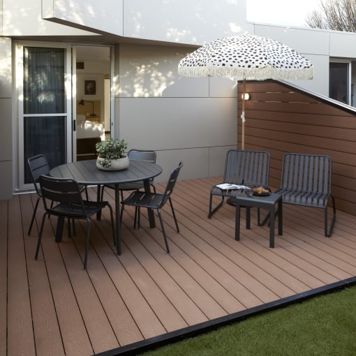 a patio with a table and chairs on a