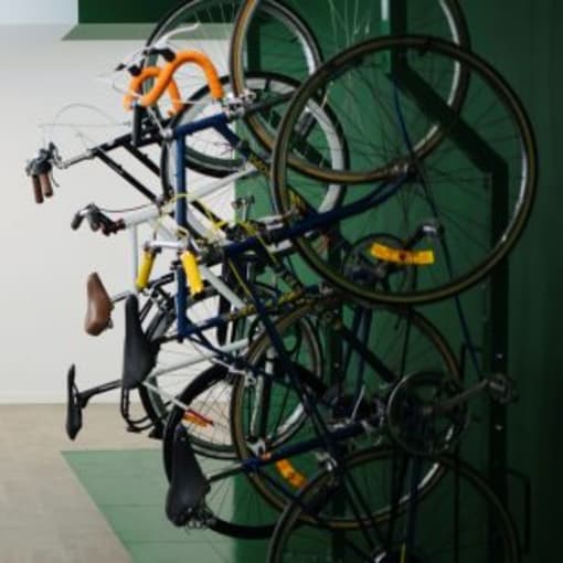 a bunch of bikes hanging on a wall in a room