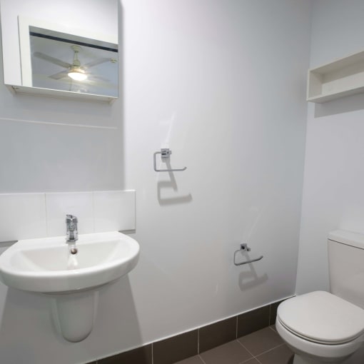 a bathroom with a sink toilet and a mirror