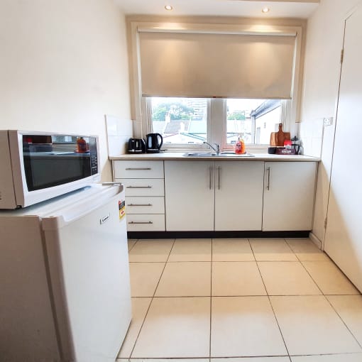 a kitchen with a sink and a microwave and a window