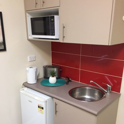 a small kitchen with a sink and a microwave