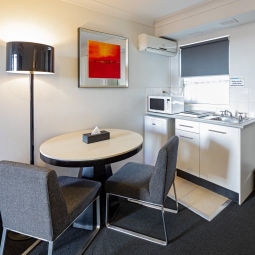 a kitchen and dining room with a table and chairs