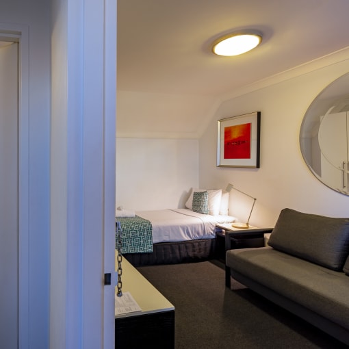 a view of a hotel room with a couch and a bed