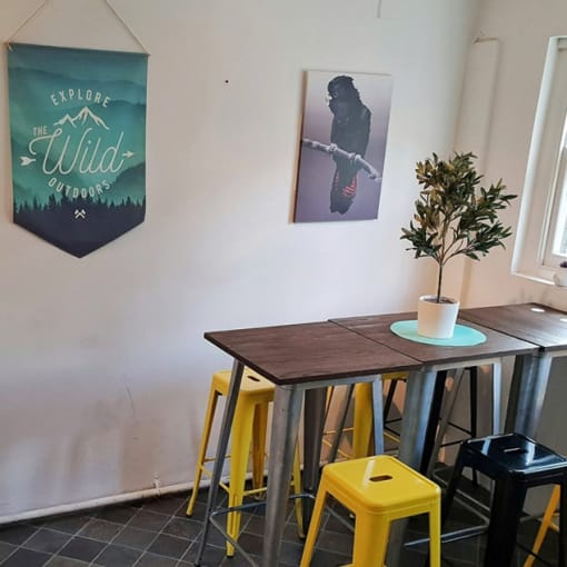 a dining room with a wooden table and yellow stools