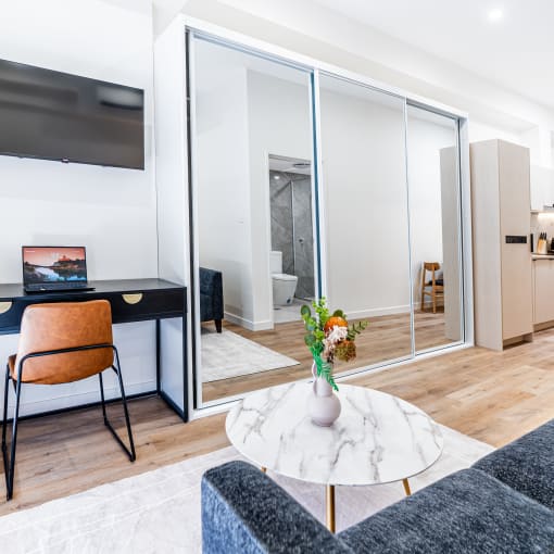 a living room with a desk and a tv