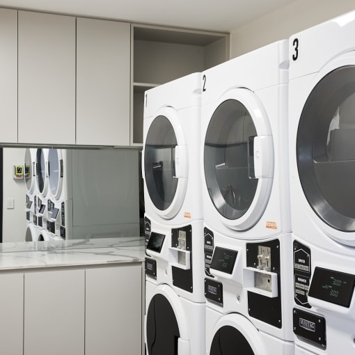 a row of washing machines in a laundry room