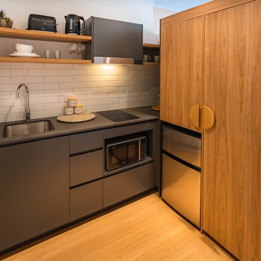 a kitchen with stainless steel appliances and a wood floor