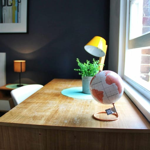 a wooden table with a globe on top of it