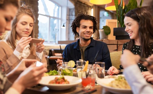 A group of people are sitting around a table eating food. at Lakeside Villas, Hampton, GA