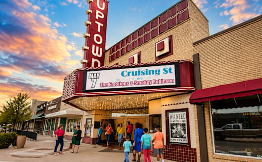 A movie theater named Uptown is shown with a sunset in the background.
