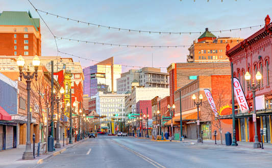 A street view of a city with buildings on either side and a street in the middle.