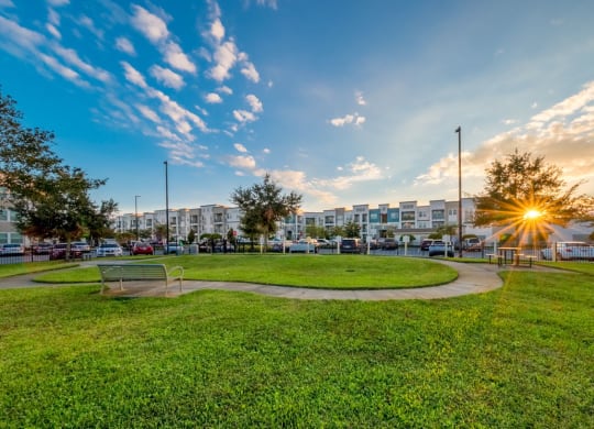 a park with green grass and a sunset in the background at Linden on the GreeneWay, Orlando
