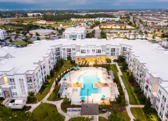 an aerial view of a building with a swimming pool  at Linden on the GreeneWay, Orlando, 32824