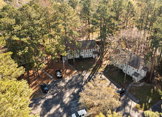 A bird's eye view of a house surrounded by trees at West Oak Apartments, North Carolina 27587
