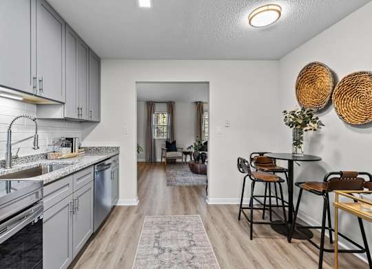 A kitchen with a dining table and chairs at West Oak Apartments, Wake Forest, NC 27587