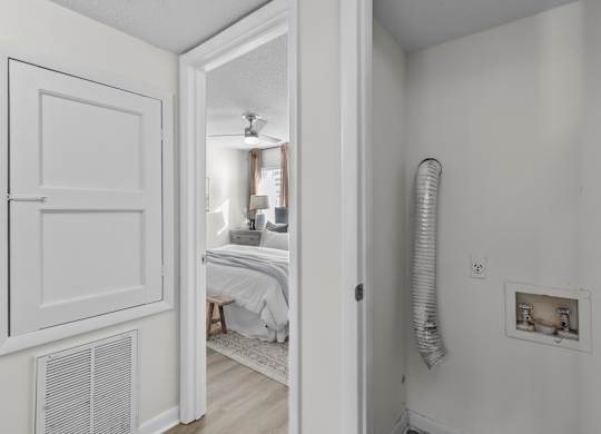 A white room with a bed and a window at West Oak Apartments, Wake Forest, NC