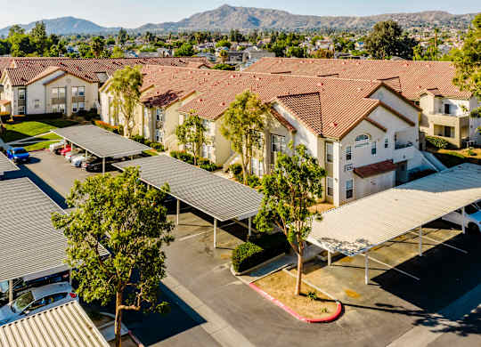 A large group of houses with a parking lot in front. at Legends at Rancho Belago, Moreno Valley, CA, 92553