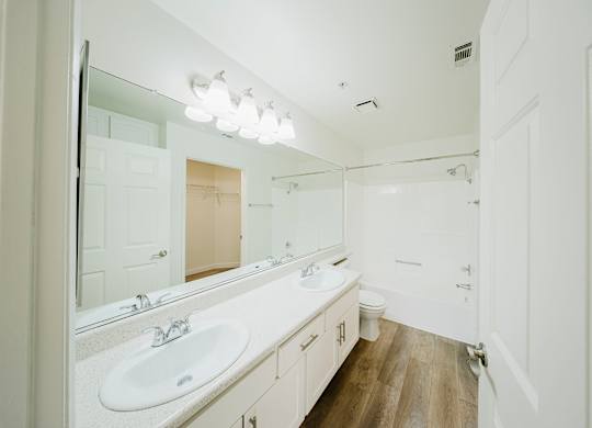 A bathroom with a white sink and mirror. at Legends at Rancho Belago, Moreno Valley, 92553