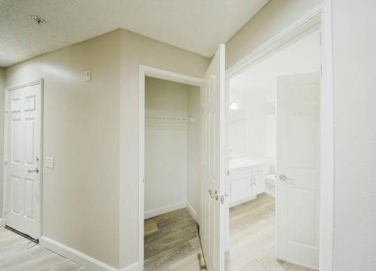 A white door is open to a room with a wooden floor. at Legends at Rancho Belago, Moreno Valley