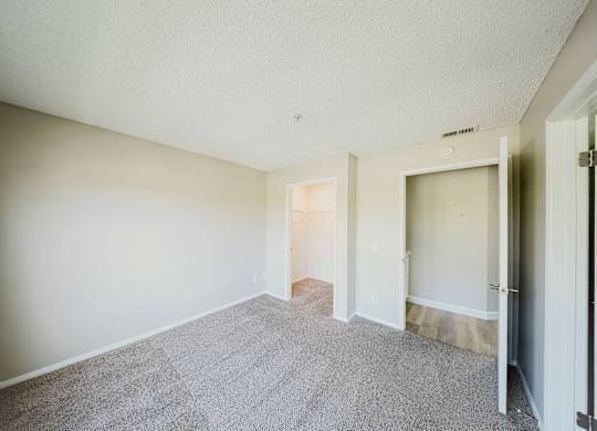 A room with a carpeted floor and white walls. at Legends at Rancho Belago, Moreno Valley