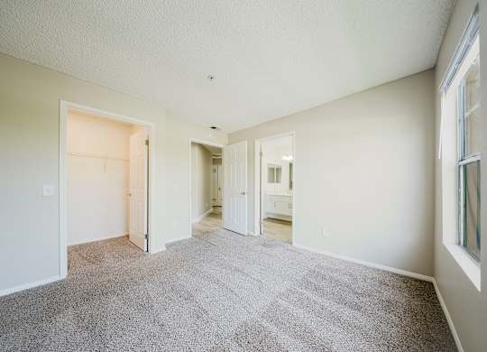 A spacious room with carpeted floor and white walls. at Legends at Rancho Belago, Moreno Valley, 92553